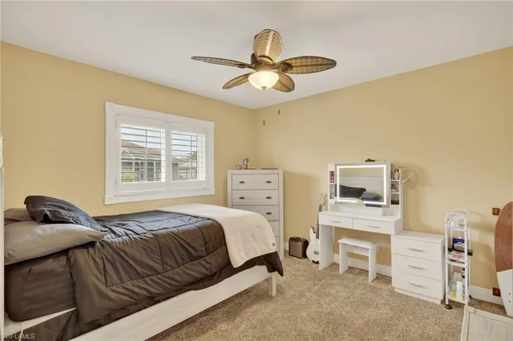 Bedroom 3 featuring light colored carpet and ceiling fan