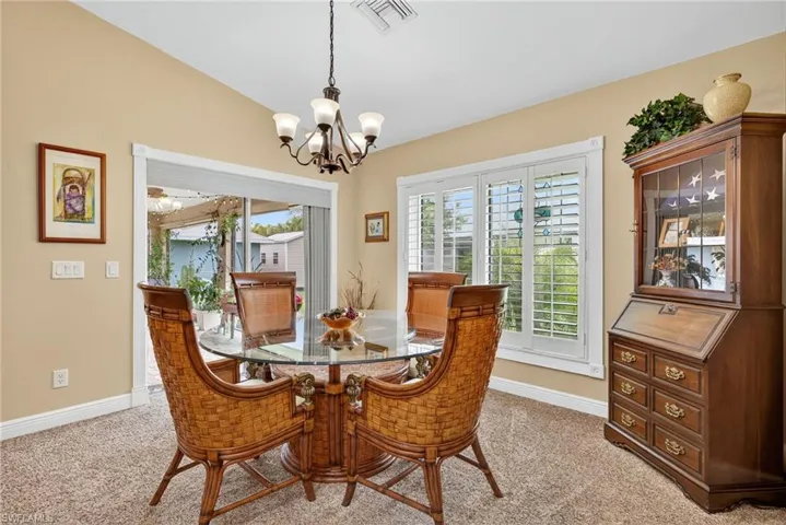 Dining area featuring carpet floors and a chandelier