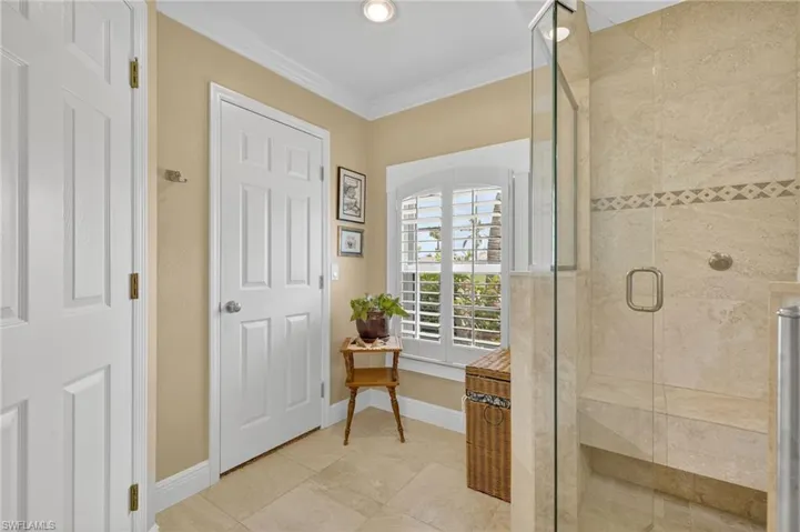 Full bath with a shower stall, crown molding, light tile patterned floors, and recessed lighting