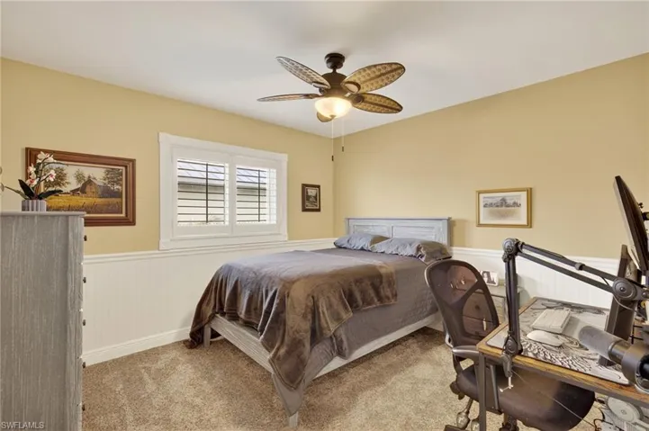 Bedroom 4 featuring wainscoting, carpet flooring, and a ceiling fan
