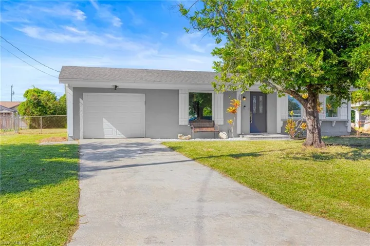 Ranch-style house featuring driveway, an attached garage, roof with shingles, and stucco siding
