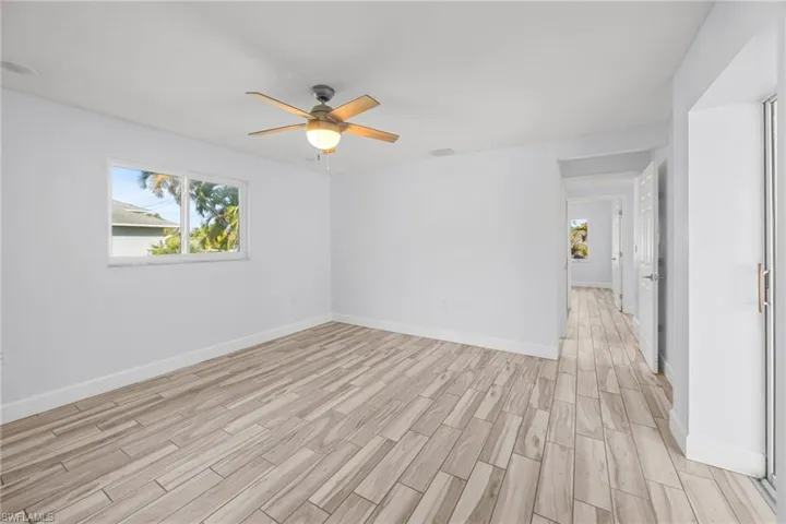 Empty room featuring wood finish floors and a ceiling fan