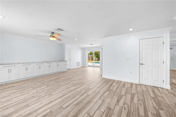 Unfurnished room featuring recessed lighting, crown molding, light wood-style flooring, and ceiling fan