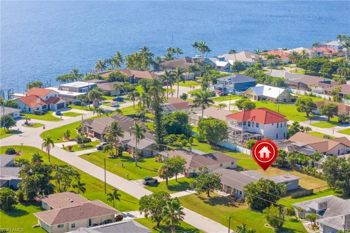 Aerial view of residential area featuring a nearby body of water