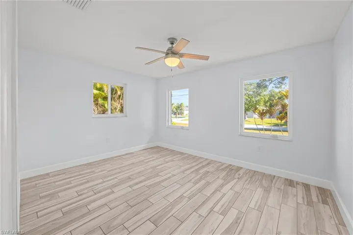 Spare room with wood tiled floors and ceiling fan
