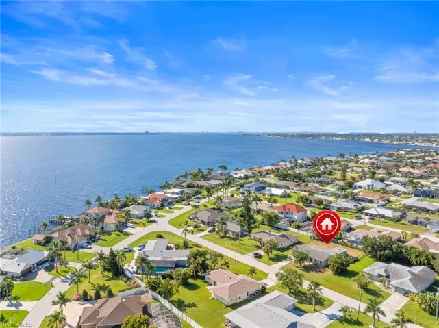 Aerial view of residential area featuring a large body of water