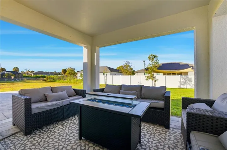 Fenced backyard featuring an outdoor living space with a fire pit and a patio