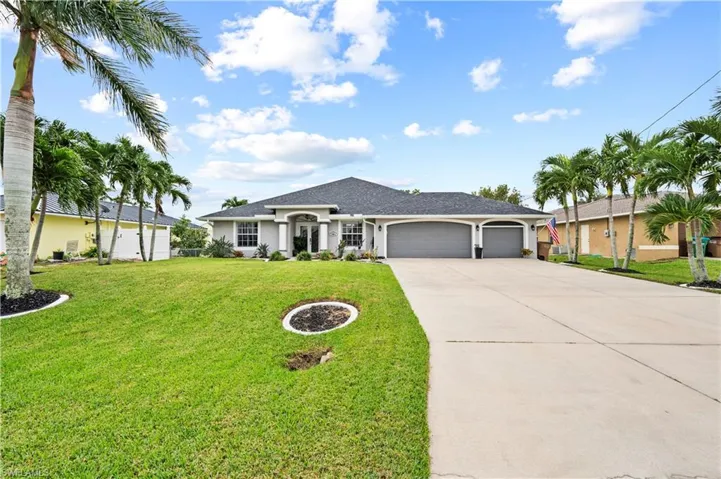 Ranch-style house featuring a front yard and a garage