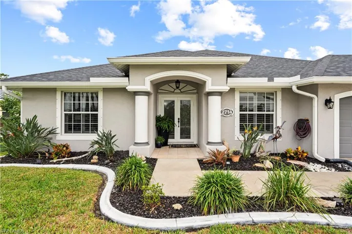 Doorway to property with french doors and a garage