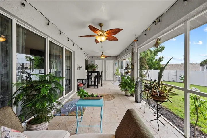 Sunroom featuring ceiling fan and plenty of natural light