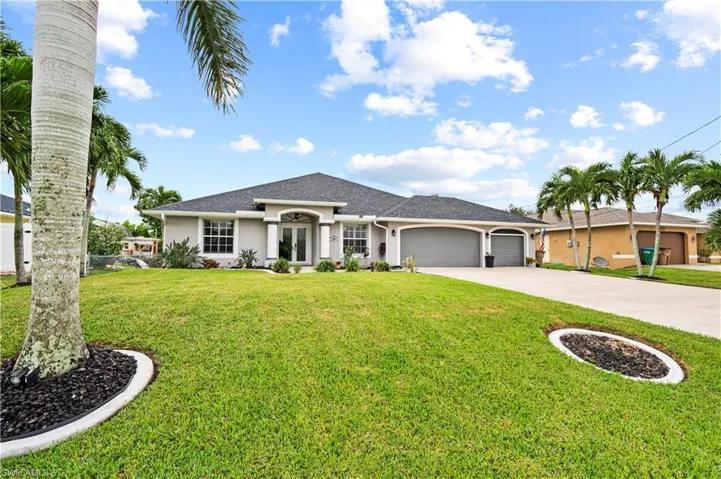 Single story home featuring a front lawn and a garage
