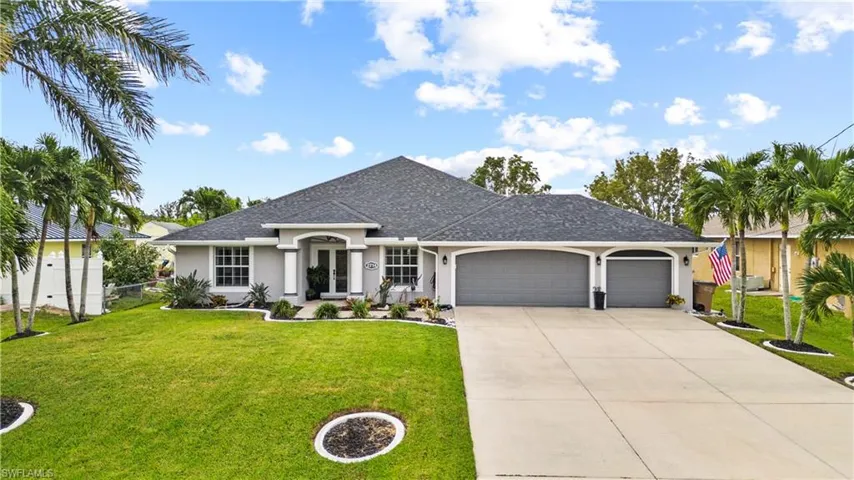 Single story home featuring a front yard and a garage