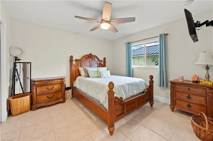 Bedroom featuring ceiling fan and light tile patterned flooring