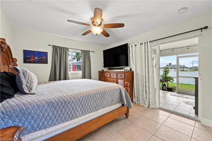 Bedroom featuring light tile patterned flooring and ceiling fan