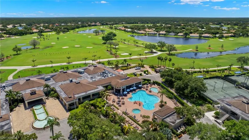 Aerial view with view of golf course and a water view