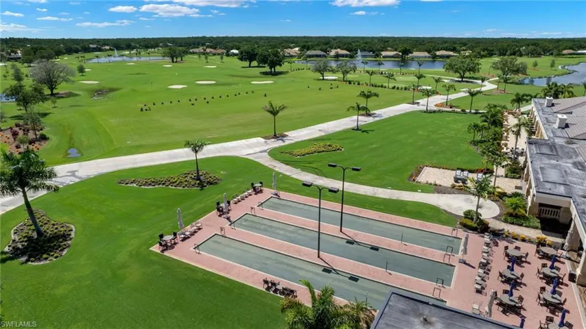 Birds eye view of property with view of golf course and a water view