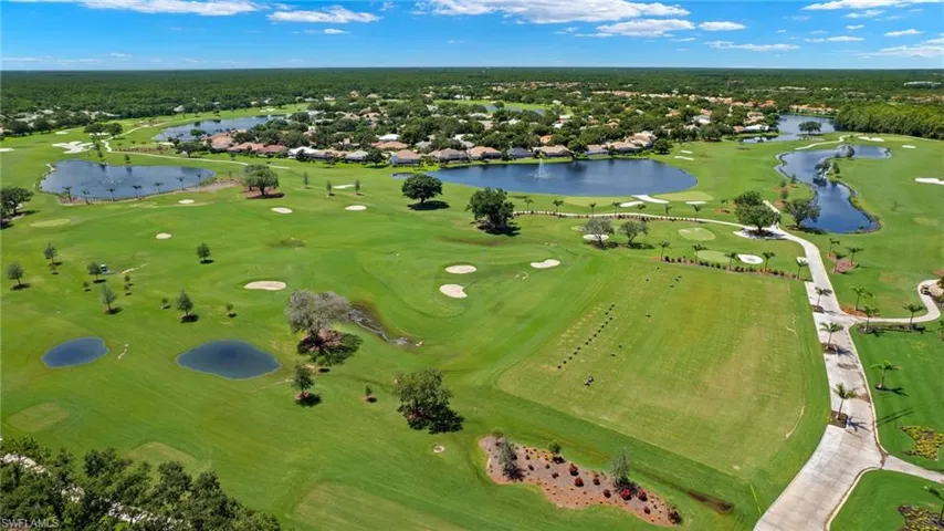 Birds eye view of property featuring view of golf course and a water view