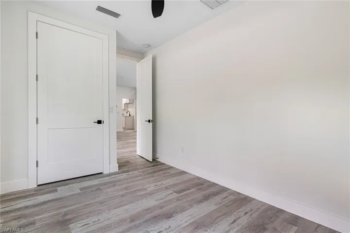 Unfurnished bedroom with baseboards, light wood-type flooring, and visible vents