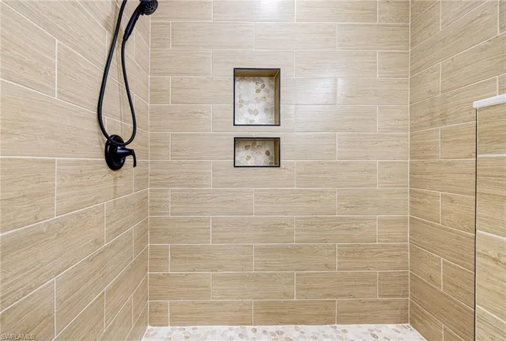 Full bathroom featuring a tile shower