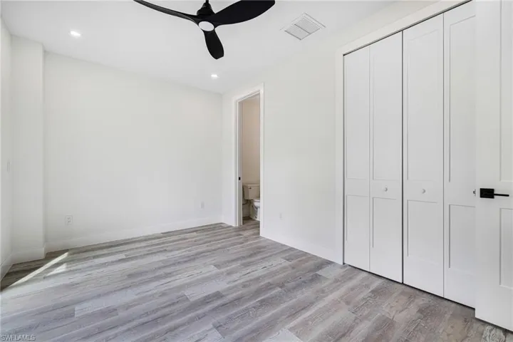 Unfurnished bedroom featuring a closet, visible vents, light wood finished floors, baseboards, and recessed lighting