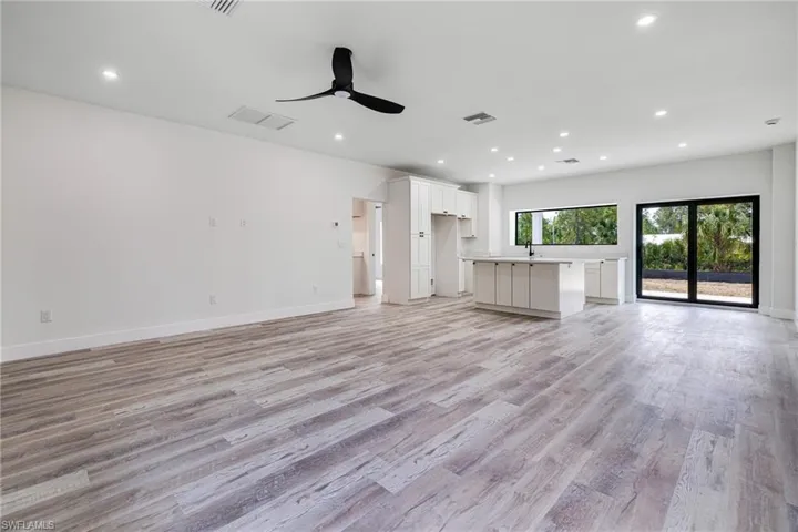 Unfurnished living room with visible vents, recessed lighting, a ceiling fan, and light wood finished floors