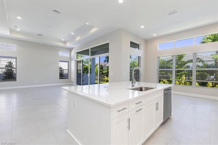 Kitchen island with a stainless steel sink and gooseneck faucet