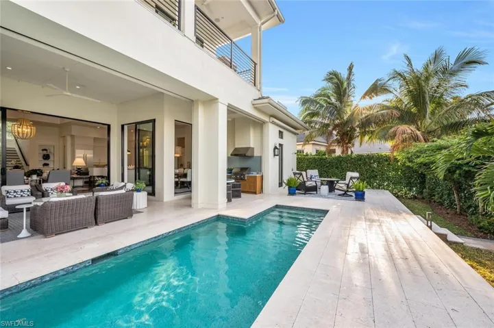 Pool, outdoor sitting area with awning retracted.