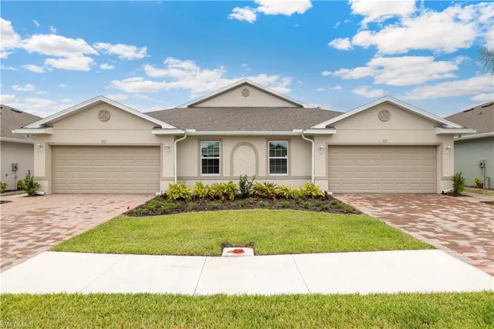 Ranch-style home with a front lawn and a garage