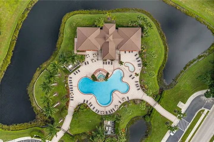 Clubhouse with a multi-level pool, integrated spa, and expansive paver patio
