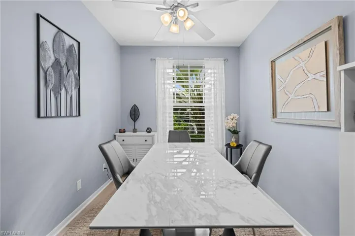 Recessed ceiling with a ceiling fan and light fixture, light-toned walls, and a window with blinds and sheer curtains