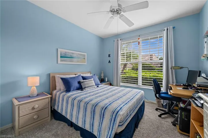 Guest Bedroom Window with horizontal blinds, overhead ceiling fan with light, and carpeted flooring