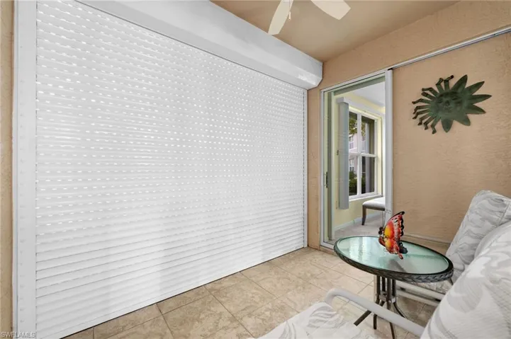 Roll-down hurricane shutters and a sliding glass door