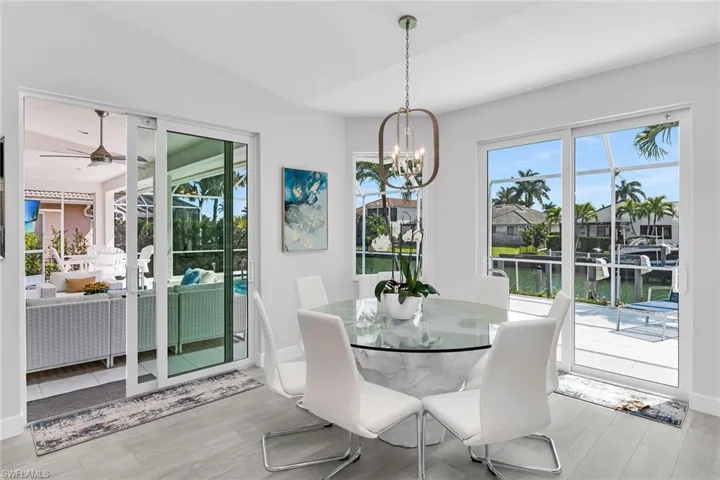 Outdoor pool with outdoor seating, a patio, a lanai, and a sunroom
