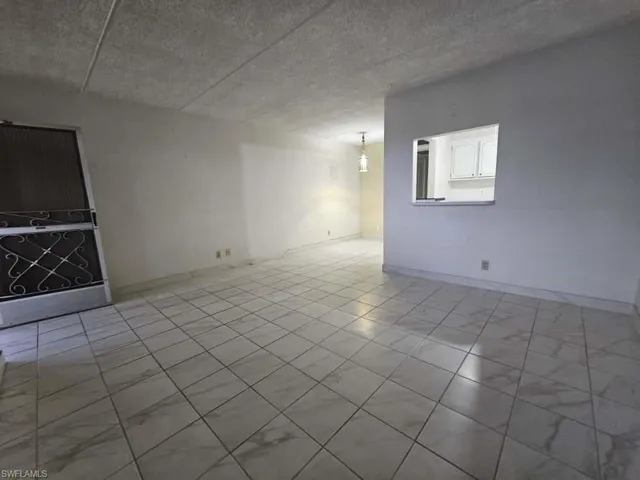 Empty room featuring baseboards