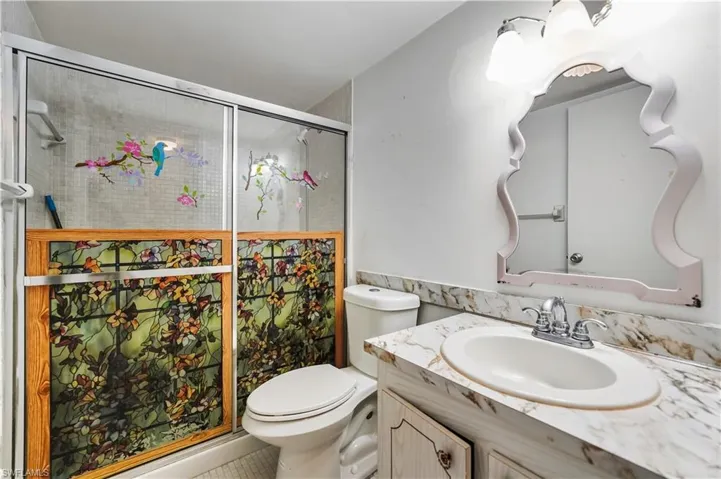 Full bath featuring vanity and a shower stall