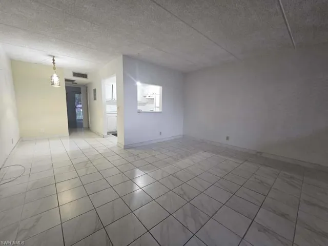 Empty room featuring baseboards
