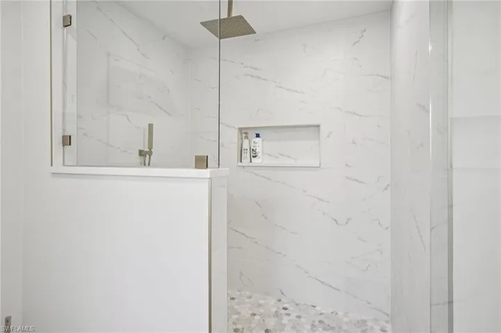 Bathroom with a marble finish shower