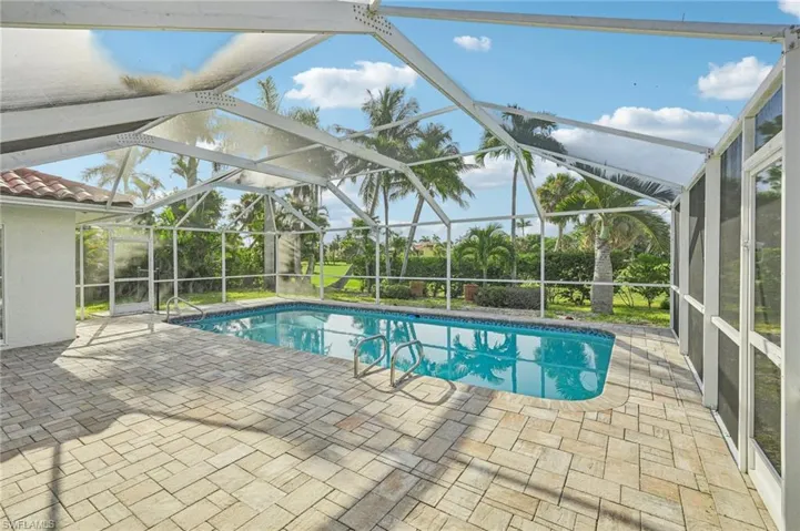 Outdoor pool with a patio area and a lanai