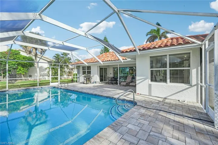 Outdoor pool with a patio and a lanai