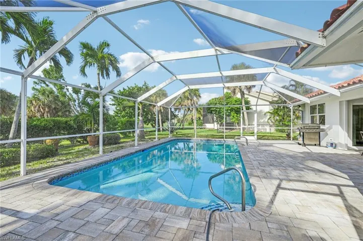 Outdoor pool featuring a patio area, a lanai, and area for grilling