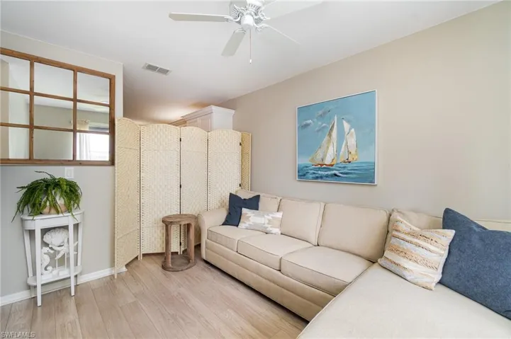 Living room featuring ceiling fan and light wood-type flooring