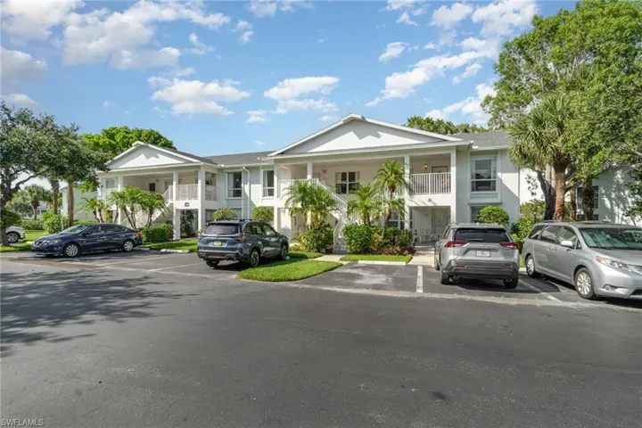 View of front of house with uncovered parking and stairway