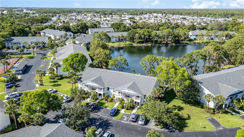 Aerial view of residential area featuring a nearby body of water