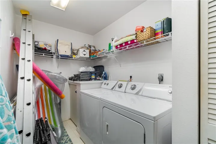 Laundry room featuring separate washer and dryer and light flooring