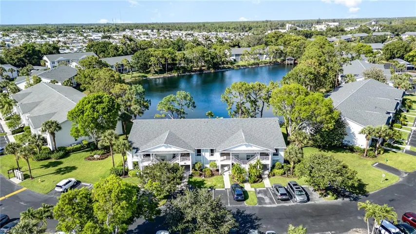Aerial view of residential area featuring a nearby body of water