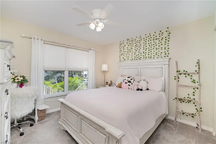 Bedroom featuring a ceiling fan and light colored carpet