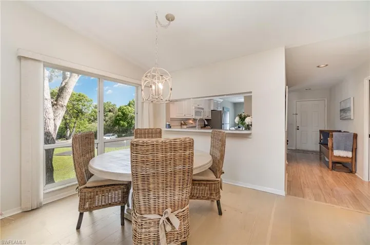 Dining area featuring light wood finished floors and a chandelier