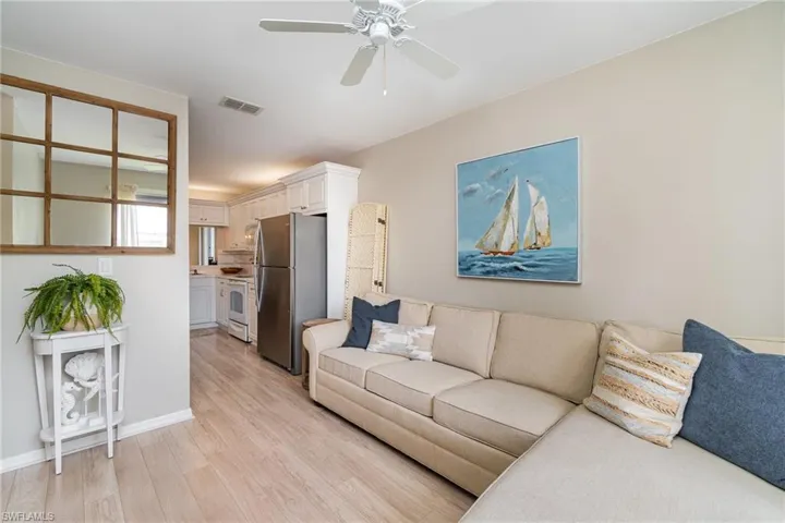 Living room featuring ceiling fan and light wood-type flooring