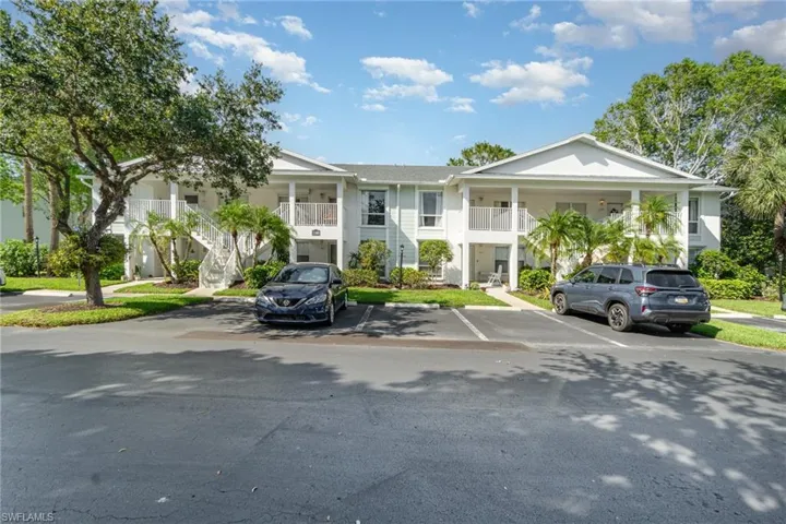 View of property featuring uncovered parking