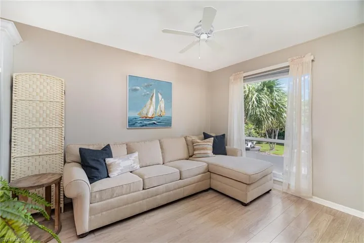 Living room with ceiling fan and wood finished floors